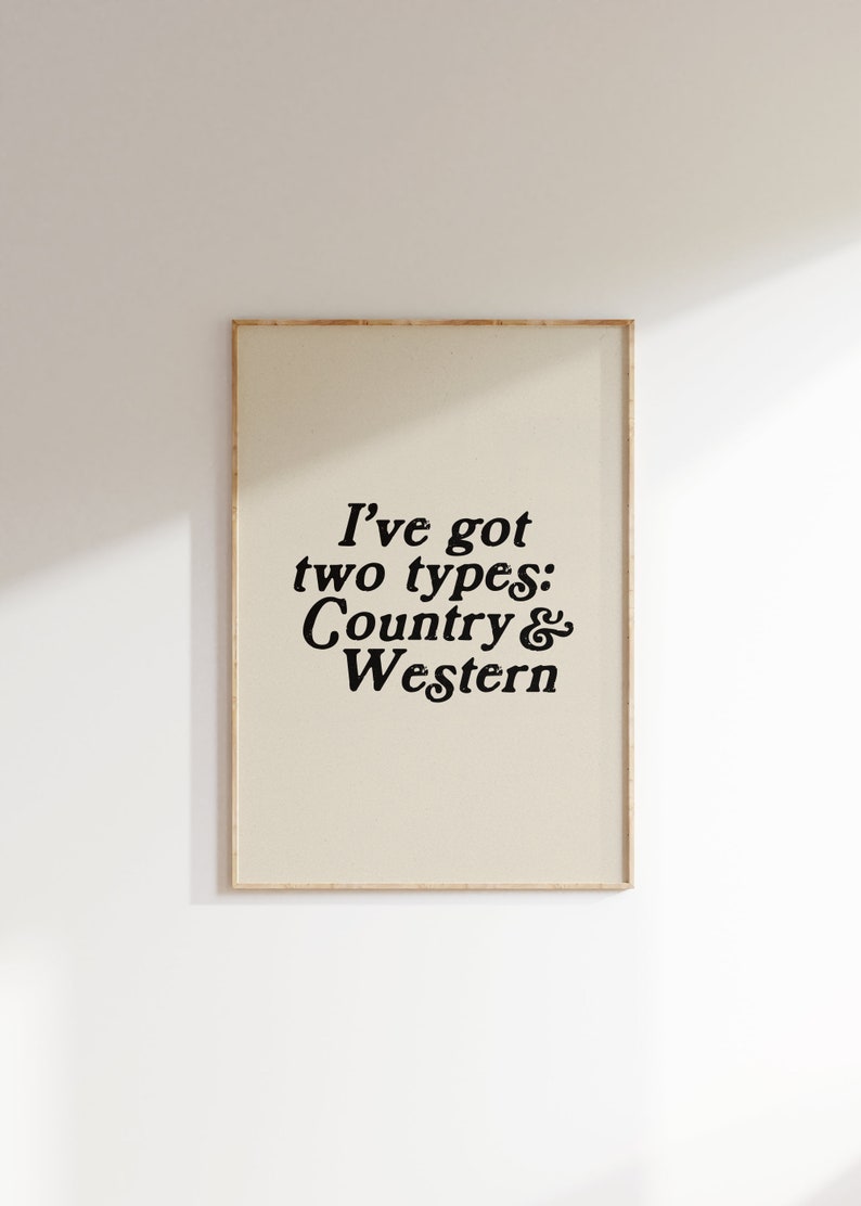 May include: A beige framed print with black text that reads "I've got two types: Country & Western".