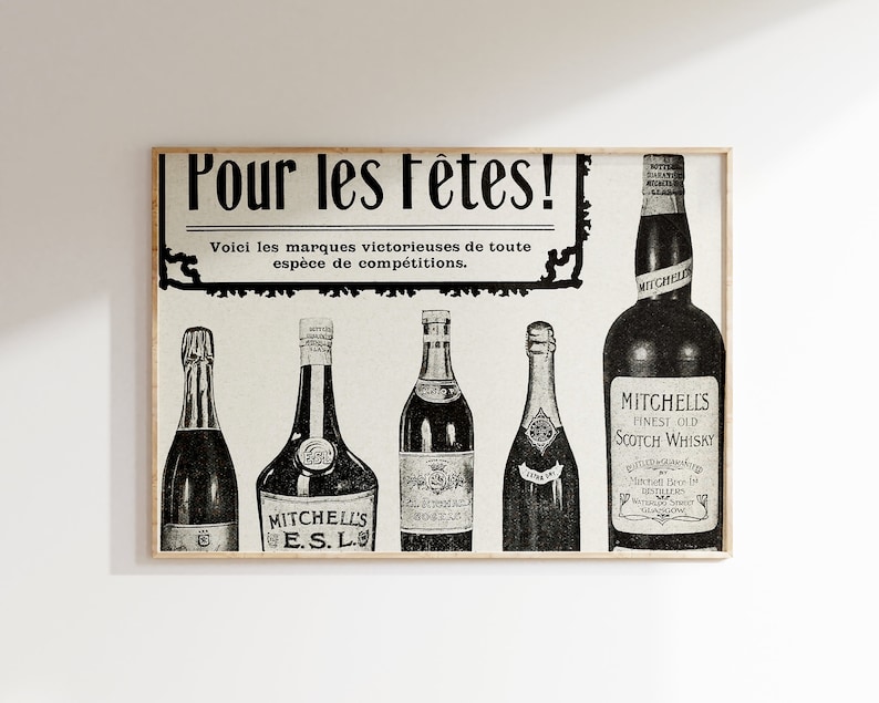 May include: Black and white vintage advertisement for Mitchell's Scotch Whisky and other alcoholic beverages. The ad features the text "Pour les F&ecirc;tes!" and "Voici les marques victorieuses de toute esp&egrave;ce de comp&eacute;titions."