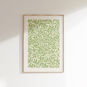 May include: A framed print featuring a green and white floral pattern. The print depicts a repeating pattern of leaves and branches.