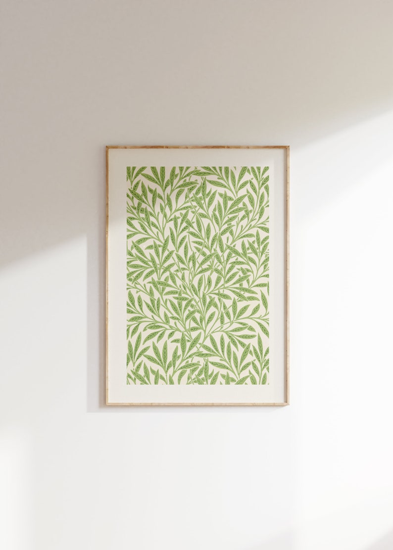 May include: A framed print featuring a green and white floral pattern. The print depicts a repeating pattern of leaves and branches.