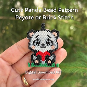 May include: A beaded panda charm in black, white, and red, with a red scarf. The charm is sitting on a green beaded base. The charm is being held in a hand. The text "Cute Panda Bead Pattern Peyote or Brick Stitch Digital Download Pdf by White Jewelry Design" is below the charm.