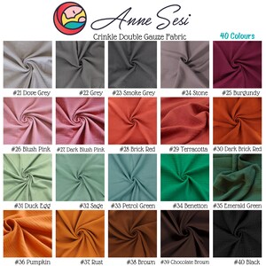 May include: Swatch card showing 40 different colors of crinkle double gauze fabric. The colors are arranged in rows of five, with each color labeled with a number and a name. The fabric is a soft, lightweight material with a crinkled texture.