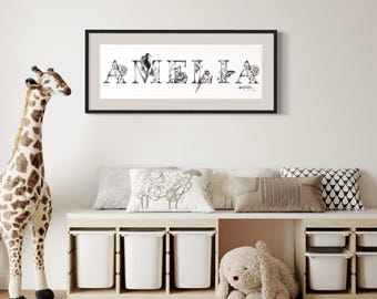 May include: A framed black and white print spelling "AMELIA" with decorative letters. The artwork is displayed above a storage bench with white bins, pillows, and a stuffed animal. A giraffe toy stands to the left.