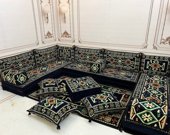 May include: A black and green patterned floor seating set with multiple cushions and pillows. The set is arranged in a traditional Moroccan style, with a large central cushion and smaller cushions around it.