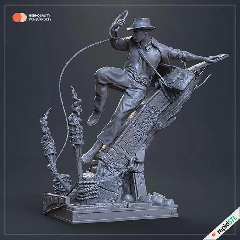May include: A gray figurine of a man in a fedora and leather jacket, swinging a whip. The figure is perched on a stone structure with torches and rope details. The base has the text "Indiana Jones". The image also includes the text "HIGH-QUALITY PRE-SUPPORTS".