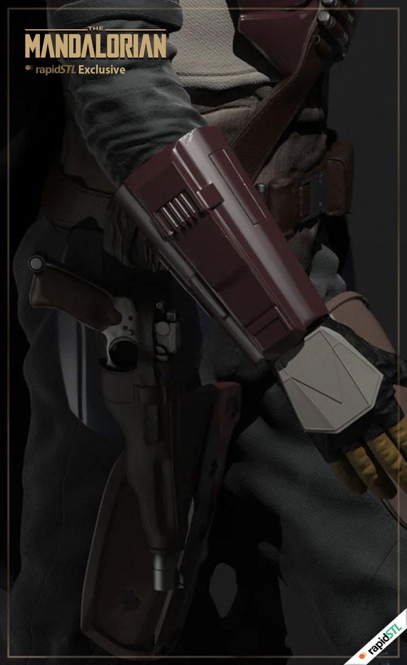 May include: A close-up of a character from the Mandalorian TV series, wearing a dark grey outfit with a brown leather belt and a red and grey forearm armor piece. The character is holding a blaster rifle in their left hand.