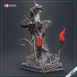 May include: A detailed statue of Indiana Jones in a dynamic pose, holding a whip and climbing. The figure is dressed in a brown hat, jacket, and pants. Two torches with orange flames flank the figure. The base features the text "INDIANA JONES".