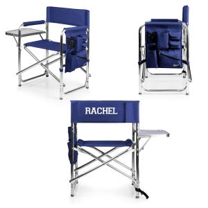 May include: A blue folding chair with a side table and a personalized name "RACHEL" on the back. The chair has multiple pockets on the back and sides.