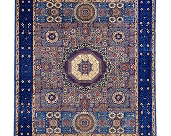 May include: A blue rug with a detailed geometric pattern in shades of red, cream, and blue. The rug has a border of small white flowers on a blue background.