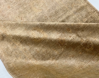 May include: A close-up of a beige rug with a subtle, textured pattern. The rug has a soft, luxurious feel and is perfect for adding a touch of warmth and elegance to any room.