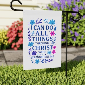 May include: White garden flag with a floral border and the text "I can do all things through Christ who strengthens me".