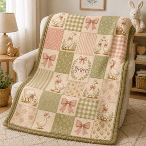 May include: A patchwork quilt featuring a repeating pattern of geese, bows, and floral designs in pink, green, and cream. The quilt has a green border and the word "Grace" is displayed in the center.