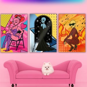 May include: Three pop art style canvas prints featuring stylized alien figures. One print shows an alien with a lollipop, another in a black gown, and the third in a red jumpsuit. A pink sofa and a small white dog are in the foreground.