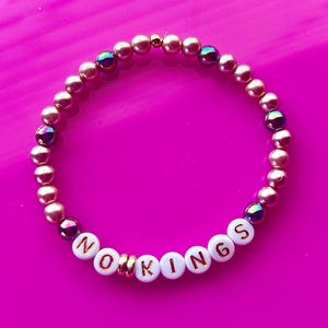 No Kings! Stand up to Trump and dictatorship!  One stretch  bracelet with gift pouch.