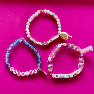 Sabrina Carpenter Short N Sweet concert custom stretch bracelet with charm. Pick your style.  Get concert ready!  Includes a jewelry pouch.