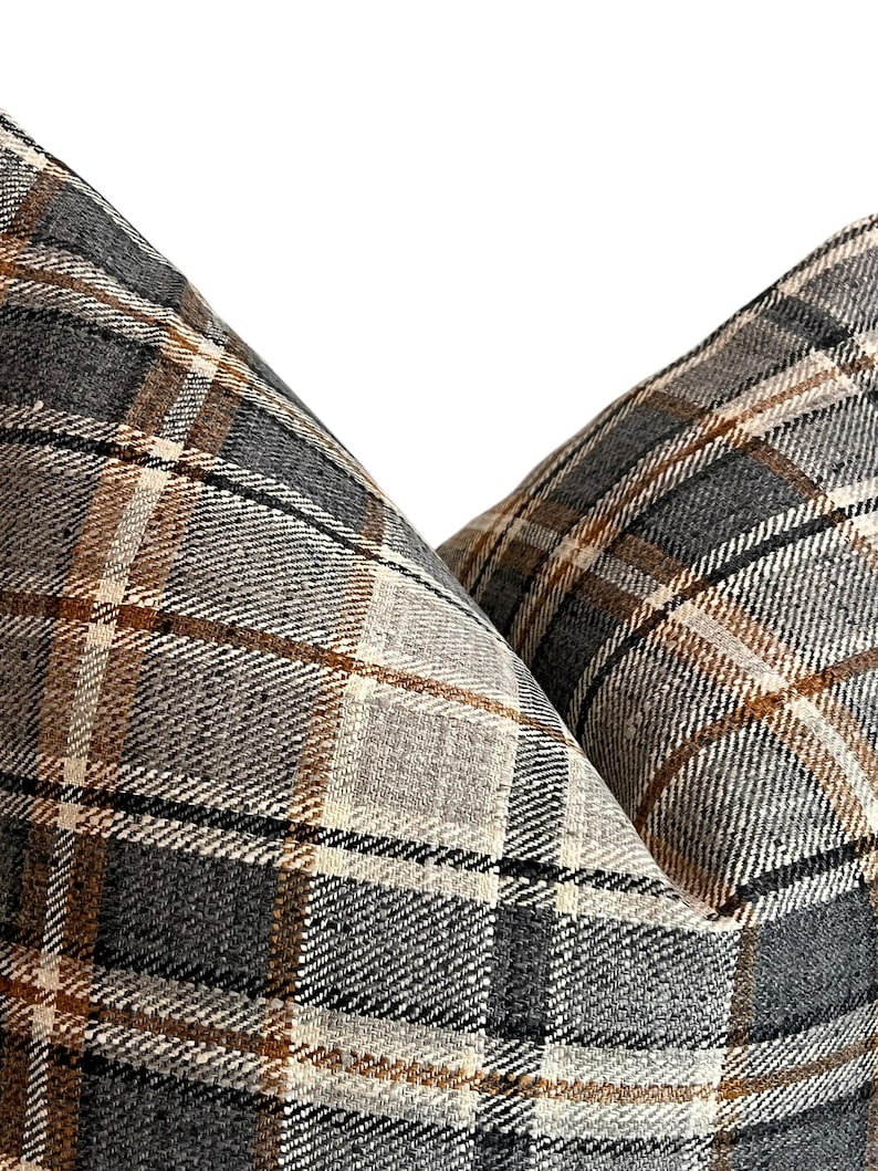 May include: Two pillow covers with a brown, beige, and gray plaid pattern.