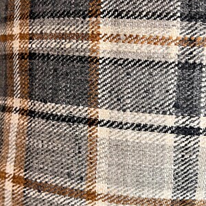 May include: Close-up of a brown, beige, and gray plaid fabric with a woven texture.