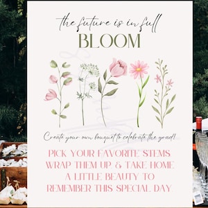 May include: A sign featuring the text "the future is in full BLOOM" and floral illustrations. The sign also includes text that reads "Create your own bouquet to celebrate the grad!" and "Pick your favourite stems, wrap them up & take home a little beauty to remember this special day."
