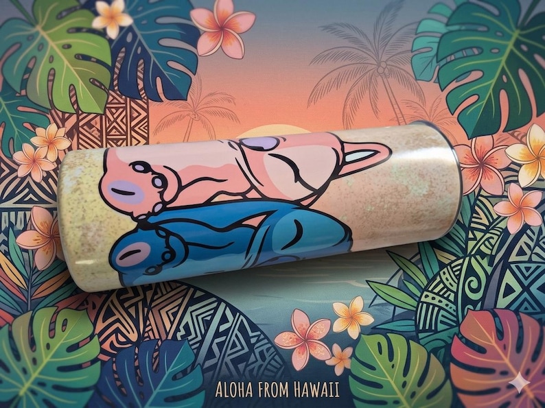 May include: A cylindrical tumbler with a cartoon illustration of two characters in pink and blue, set against a tropical background with palm trees and flowers. The text "Aloha From Hawaii" is at the bottom.