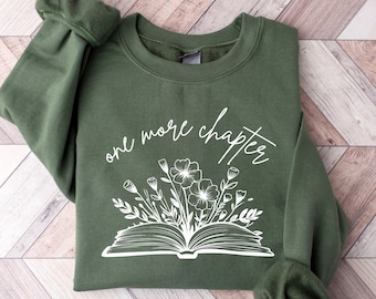 May include: A green sweatshirt with a white graphic of an open book with flowers and the text "one more chapter".