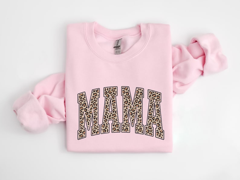 May include: Pink sweatshirt with a leopard print "MAMA" graphic.