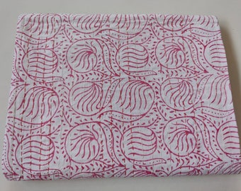 May include: A white cotton quilt with a pink floral pattern. The quilt is hand-stitched and has a traditional Indian design.