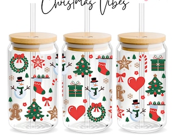 May include: Three clear glass 16oz can wraps with a bamboo lid and a straw. The wraps are decorated with a Christmas theme featuring red and green illustrations of a snowman, a Christmas tree, a gingerbread man, a candy cane, a stocking, a star, a heart, a wreath, and a gift box.