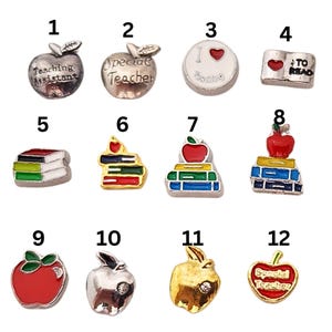May include: Twelve charm pendants with various designs related to teaching. The charms are silver, gold, and red with black, blue, green, and yellow accents. The charms feature images of apples, books, and text that says "Teaching Assistant", "Special Teacher", "I Love Teaching", and "To Read".