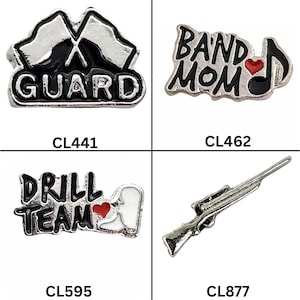 May include: Four metal charms with black and silver accents. One charm says "GUARD" with flags, another says "BAND MOM" with a musical note and heart, a third says "DRILL TEAM" with a heart, and the last is a rifle. Each charm has a product code.