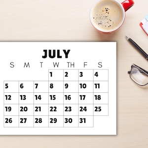 A calendar with large font and numbers on a desk.
