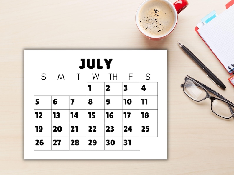 A calendar with large font and numbers on a desk.