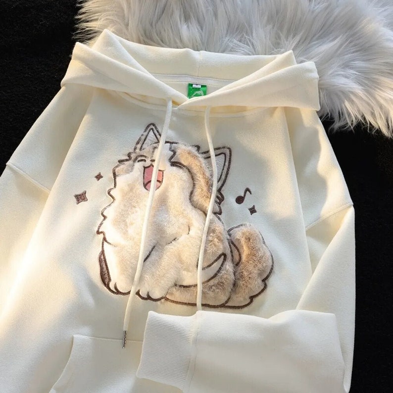 Joyful singing cat design on apricot hoodie