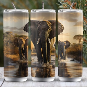 May include: Three stainless steel tumblers featuring a design of elephants walking through a savanna at sunset. The elephants are walking through a shallow body of water. The tumblers are a popular choice for outdoor activities and everyday use.