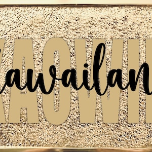 May include: A gold-colored rectangular plaque with the word "Kawaiilana" in black script. The background is textured, and the edges feature floral and scroll designs.