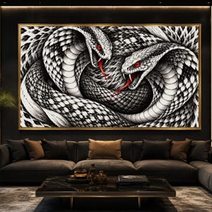 May include: A rectangular wall art piece featuring a detailed black and white illustration of two intertwined snakes with scales, open mouths, sharp fangs, and striking red eyes and tongues, all enclosed within a thin gold-coloured frame.