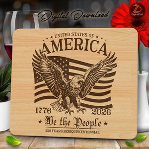 May include: A light-colored wooden cutting board with an engraved design featuring an American flag, an eagle, and the text "UNITED STATES OF AMERICA", "1776", "2026", and "We the People". The board celebrates the 250th anniversary.