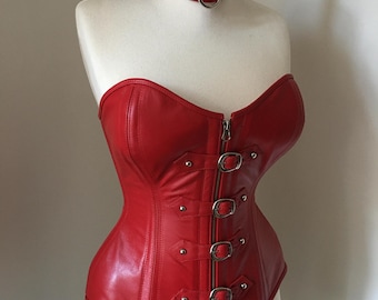 May include: A red leather corset with silver buckles and a matching red leather choker with silver studs and a ring.