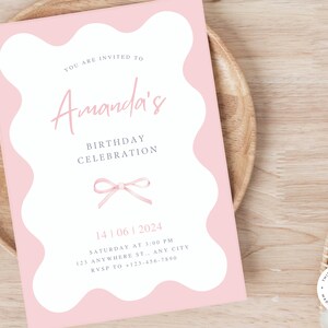 May include: Pink birthday invitation with a white border and a pink bow. The invitation says "You are invited to Amanda's Birthday Celebration" and includes the date, time, and location of the event.