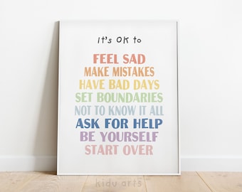 Könnte beinhalten: Ein weißer gerahmter Druck mit einem regenbogenfarbenen Textüberlagerung. Der Text lautet "It's Ok to" gefolgt von einer Liste von Sätzen: "Feel Sad", "Make Mistakes", "Have Bad Days", "Set Boundaries", "Not to Know It All", "Ask for Help", "Be Yourself", und "Start Over".