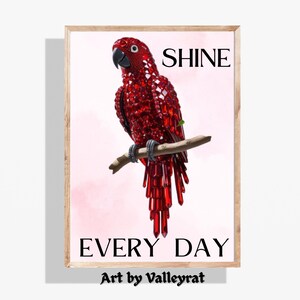 May include: A red parrot made of crystals is perched on a branch. The parrot is surrounded by a pink background with the words "SHINE EVERY DAY" and "Art by Valleyrat" written below the parrot.