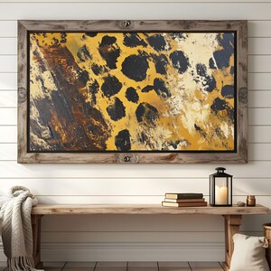 Puede incluir: Una pintura abstracta enmarcada con un esquema de color amarillo, marr&oacute;n y negro. La pintura presenta un patr&oacute;n de grandes manchas negras irregulares sobre un fondo amarillo.