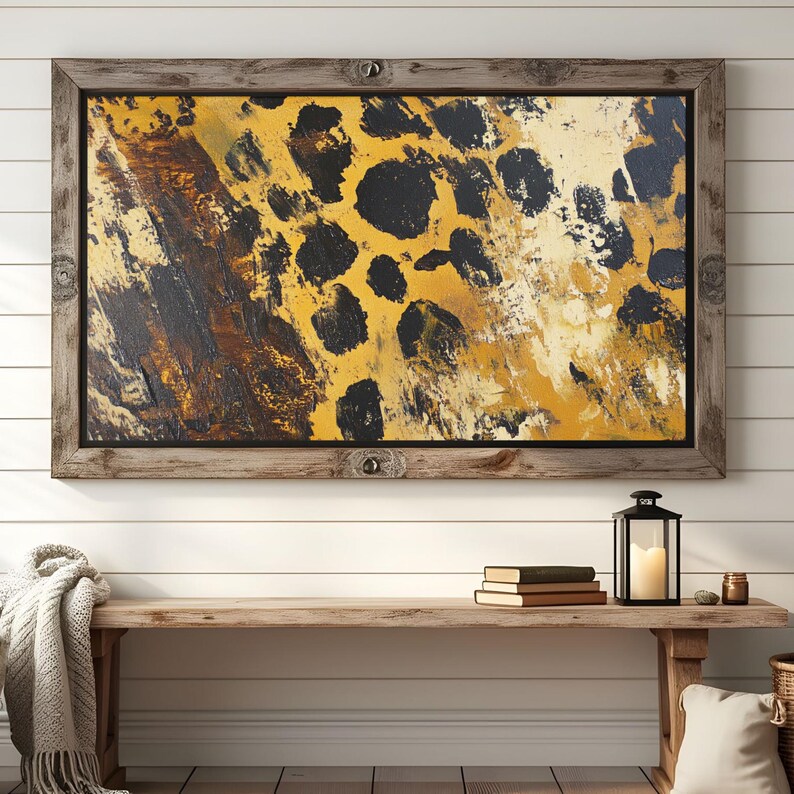 Puede incluir: Una pintura abstracta enmarcada con un esquema de color amarillo, marr&oacute;n y negro. La pintura presenta un patr&oacute;n de grandes manchas negras irregulares sobre un fondo amarillo.