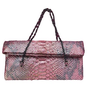 May include: A pink and grey snakeskin-patterned handbag with a chain strap. The bag is rectangular with a fold-over flap. The chain strap is black with a red interior.