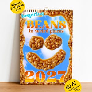 May include: A 2027 wall calendar featuring a border of baked beans and a central blue sky background. The text reads inspiring BEANS in weird places 2027. Baked beans are arranged to form a smiley face in the center of the calendar page.