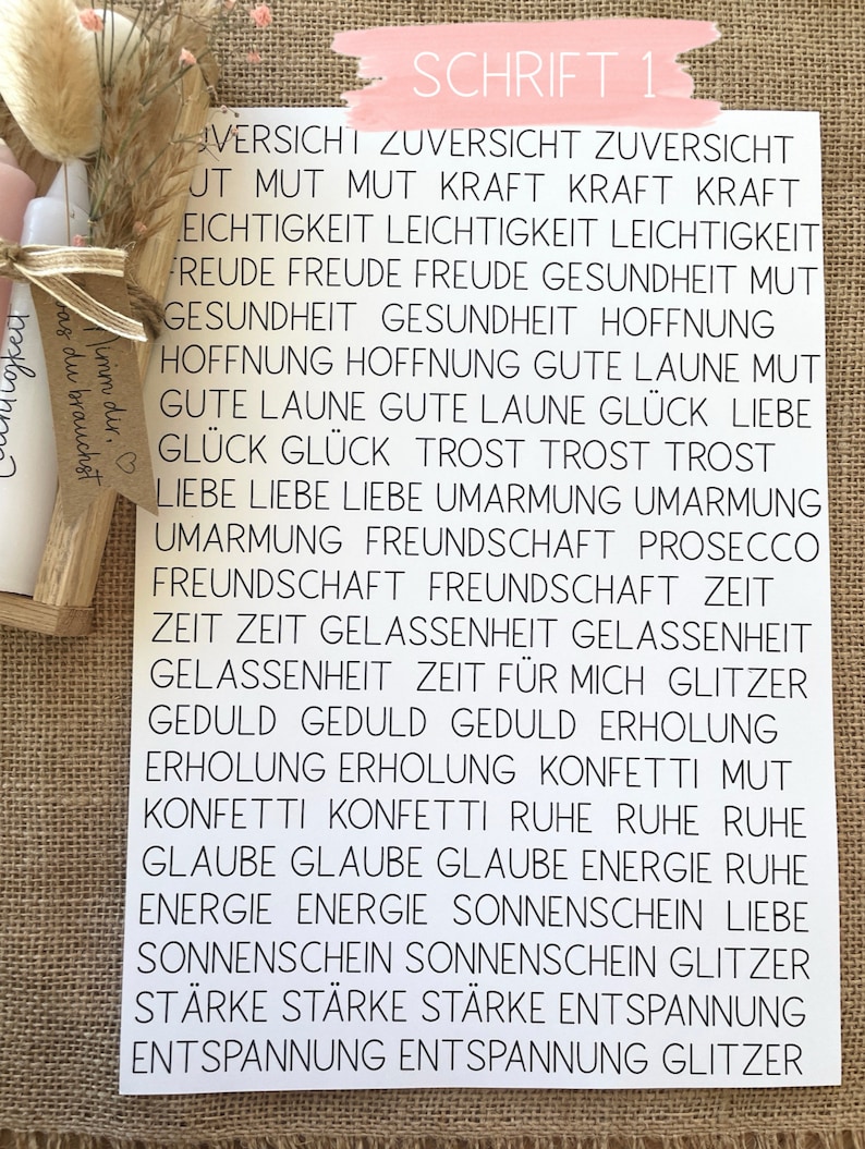 May include: A white sheet of paper with black text listing positive words and phrases in German. The words are arranged in columns and include words like "Mut" (courage), "Freude" (joy), "Hoffnung" (hope), "Liebe" (love), and "Gl&uuml;ck" (happiness).