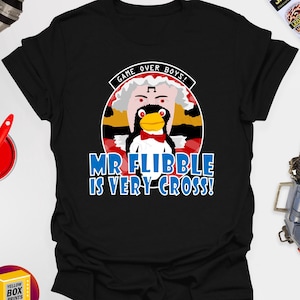 May include: Black t-shirt with a white and red illustration of a penguin wearing a bow tie and a white hat. The text "GAME OVER BOYS! MR FLIBBLE IS VERY CROSS!" is printed in blue on the shirt.