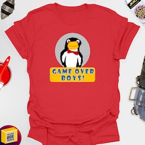 May include: Red t-shirt with a cartoon penguin wearing a bow tie and the text "GAME OVER BOYS!" printed on it.