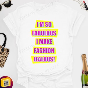 May include: White t-shirt with a graphic print that says "I'm so fabulous I make fashion jealous!" in pink and blue letters on a yellow background.