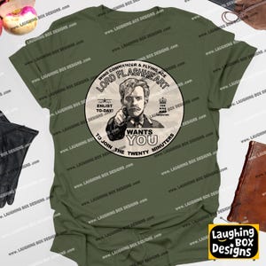May include: Olive green t-shirt featuring a circular graphic with the text "LORD FLASHHEART" and an illustration of a man pointing. The graphic also includes the words "Wants You" and "Enlist To-Day!"