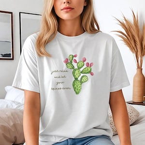 May include: White t-shirt with a green cactus illustration and the text "just relax and let your spines down".